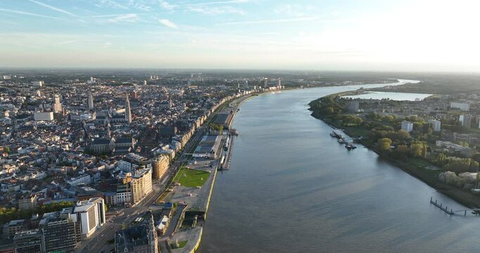 City view of Antwerp, Belgium at sunset. Skyline at the Schelde river. Aerial drone video, golden hour.