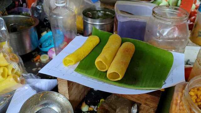 Closeup video of famous wheat flour snacks or fryums , salted refill on a banana leaf