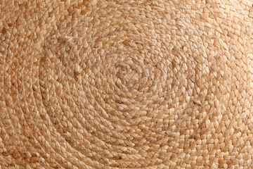 A close up of a woven rug with a circular pattern