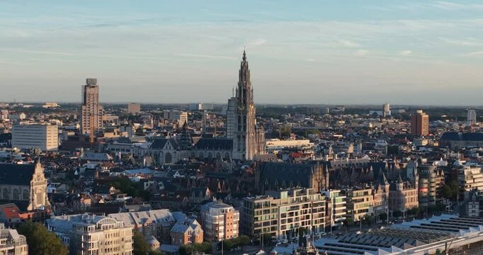 City view of Antwerp, Belgium at sunset. Skyline at the Schelde river. Aerial drone video, golden hour.
