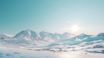 A beautiful mountain range covered in snow under a clear sky.
