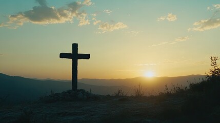 Scenic cross silhouetted against a sunset sky, representing faith and hope without any people present.