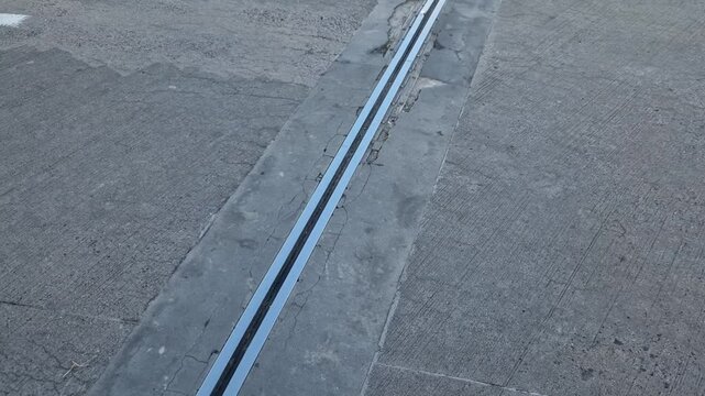 roof structure or bridge expansion for safe connection of two expandable concrete bodies. rubber joint in a metal bar, cracked, eroded, video, curb, renovation frost, salt, crack, crushed