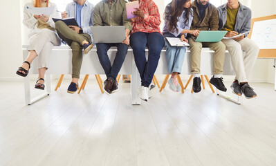 Close up midsection shot of a diverse team of business people or students working or learning...