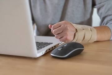 Person Typing On Laptop Experiencing Hand Pain, Wrist Tendinitis Symptoms From Repetitive Typing...