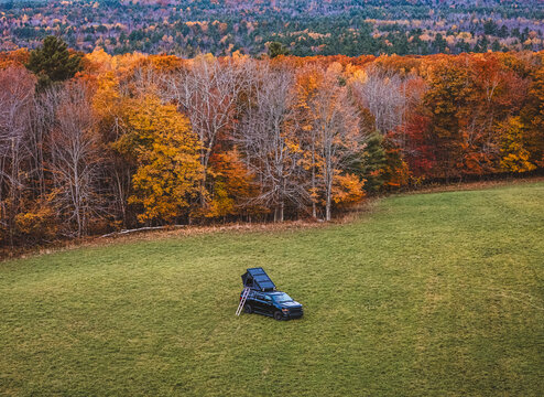 truck with roof top tent at campsite in Maine with fall foliage