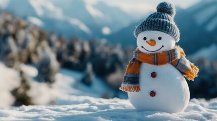 Fototapeta premium Snowman with a woolen scarf and hat, with a snowy mountain backdrop and room on the left for copy space.
