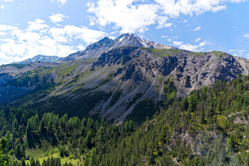 Alpine landscape at Swiss mountain pass named Pass dal Fuorn with mountain peak Piz Daint and Piz...