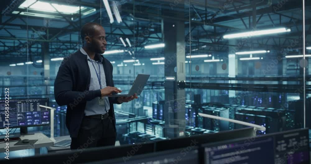 Aufkleber Black Male Software Developer Analyze System Performance Metrics on a Laptop Inside a Modern Data Center. Young Manager Ensuring Efficient Operations for Critical Infrastructure