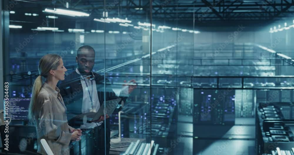 Leinwandbilder two data center engineers, a black male and a caucasian female, collaborate using a laptop computer 
