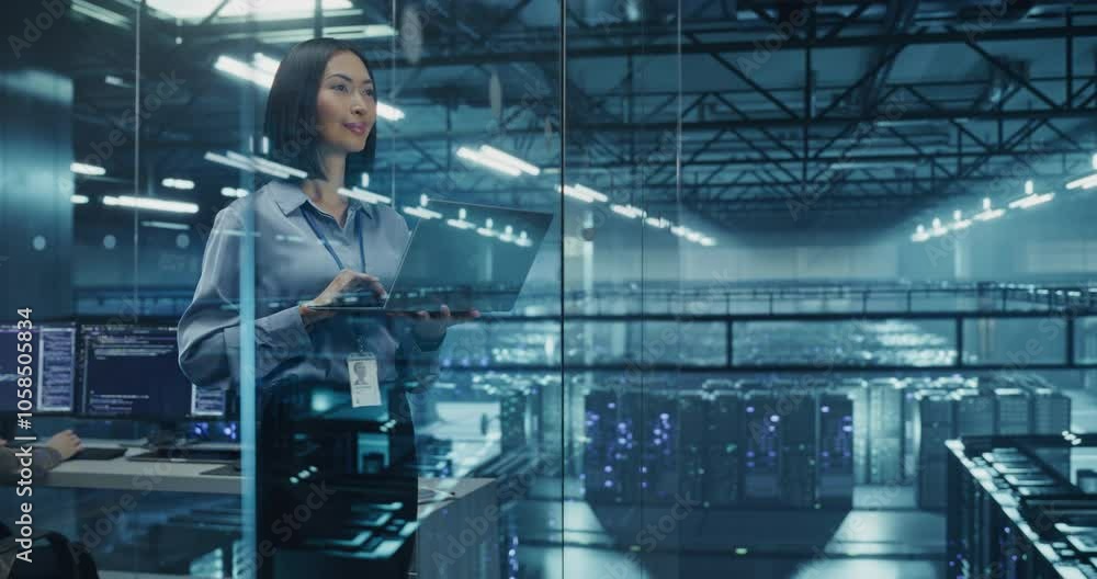 Poster Asian Female Data Analyst Studies Traffic Logs on Her Laptop Computer, Standing in a Modern Data Center with Server Systems. Young Woman Searching for Patterns to Improve Online Data Flow