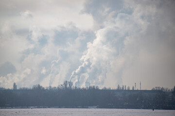 A large cloud of smoke is rising from a factory