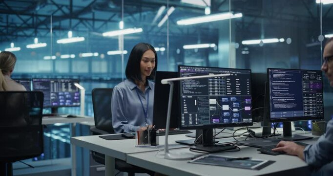 Diverse Team of Developers with a Focus on Asian Female Collaborate in a Modern Data Center, Optimizing Systems and Building Cybersecurity Through Advanced Coding and Data Analysis - Powered by Adobe