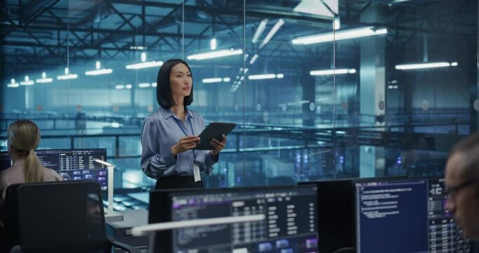 Asian Female DevOps Engineer Monitoring Automation Scripts on Her Tablet Computer, Streamlining Processes of the Data Center IT Infrastructure. Software Specialist Working in Data Protection Field