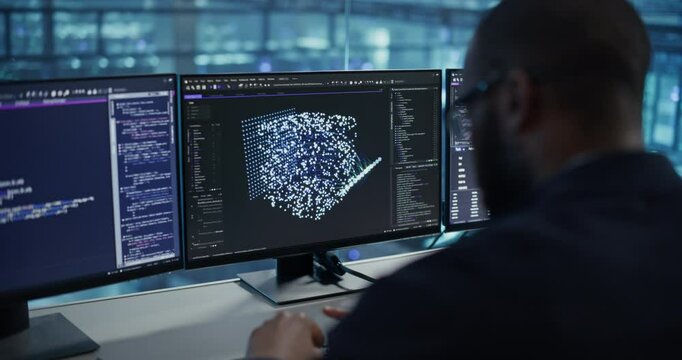 Male Software Engineer Focused on Working on a Machine Learning Model Displayed Across Three Monitors. Black Specialist Analyzing Data Outputs and Tweaking Parameters in Real Time