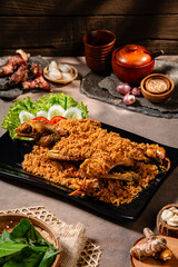 Ayam Kampung Goreng kremes. Traditional fried chicken with spice crumbs from Minangkabau, West Sumatra