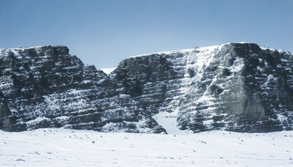 Snowy stone mountain. Snow covered rocky mountain
