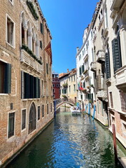 Travel through the narrow waterways of Venice by boat between ancient houses and under the bridges that connect them.