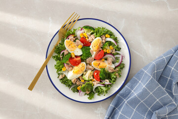 Salad with tuna on a light table.