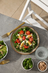 Salad with tuna on a gray table.