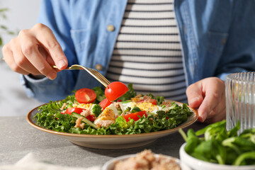 Salad with tuna on a gray table.