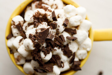 Cocoa and marshmallows in yellow ceramic cup