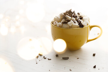 Cocoa and marshmallows in yellow ceramic cup