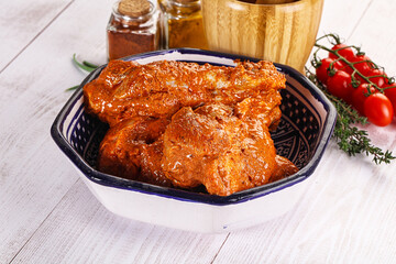 Raw turkey shoulder wing in Indian tandoori marinade