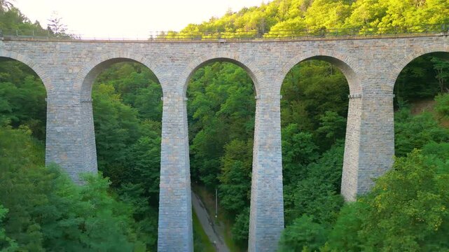 Experience the beauty of the Zampach railway bridge, the highest stone bridge in Czechia, surrounded by lush green forests and stunning natural scenery.