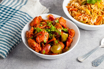 Chilli chicken is a spicy Indo-Chinese dish featuring crispy fried chicken tossed in a tangy, savory sauce with peppers and onions.