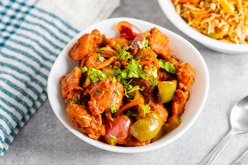 Spicy, tangy, and savory, chili chicken features crispy fried chicken tossed in a bold sauce with garlic, green chilies, and vibrant bell peppers.