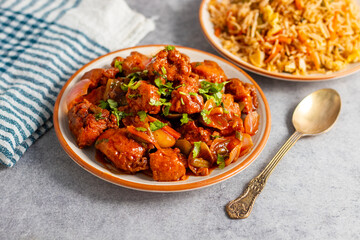 Chilli chicken is a spicy Indo-Chinese dish featuring crispy fried chicken tossed in a tangy, savory sauce with peppers and onions.