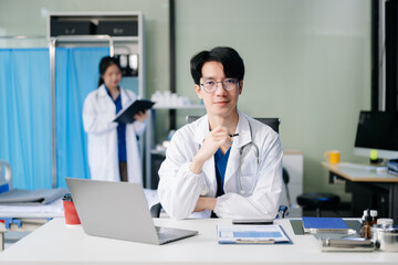 Doctor analyzing patient data on tablet in clinical lab. Medical professional in hospital with laptop, blood samples