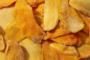 Dried mango chips on a white background