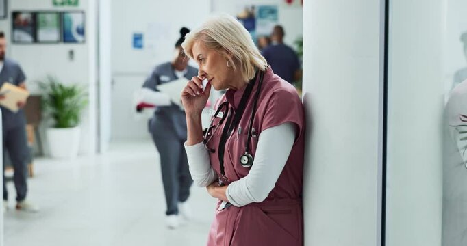 Mature woman, nurse and stress with headache at hospital for fatigue, anxiety and burnout at work. Healthcare, trauma and worker overwhelmed with patient loss, medical mistake and bad news in lobby