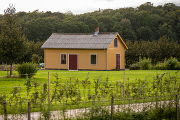 Yellow wooden house in a park.