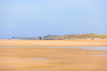 The beach in the Dutch city of Bergen on a sunny day with a blue sky