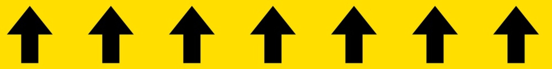 Black arrows in continuous order on yellow background. Arrows direction sign horizontal tape. Flow direction tape. A long horizontal stripe. 