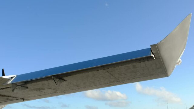 Closeup of fraise type aileron on the wing of lightweight aircraft. Checking the aircraft controls before take-off or after maintenance. Operation of airplanes aileron check.