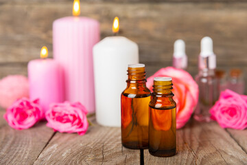 Rose essential oil on a textured background.Roses and a bottle of rose perfumed water.Aromatherapy treatment. Beauty concept. Spa procedure.Natural organic oil.Anti-stress,detox relax.Place for text