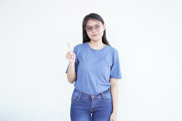 beautiful Asian woman makes a one-finger gesture, emphasizing her point against a clean white...