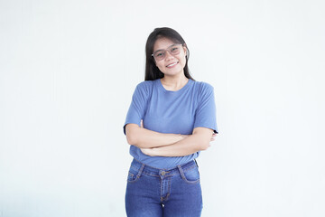beautiful Asian woman stands with her arms crossed over her chest, conveying confidence against a...