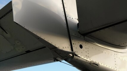 Closeup view on the tail and elevator of lightweight aircraft during the checking it controls. Checking the controls movements of the aircraft before take off or after maintenance.