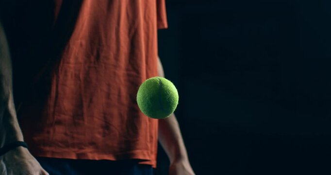 Super slow motion close up of paddle player is warming up with  ball before competition game match or training workout on indoor court at 1000 fps.