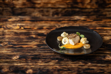 Grilled Fish with Pumpkin Puree and Vegetables on Plate