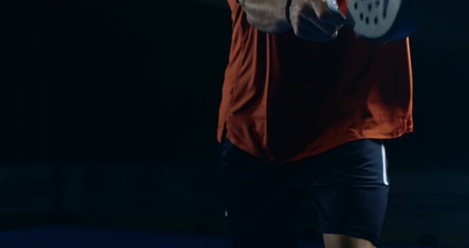 Super slow motion close up of paddle player is hitting ball during competition game match or training workout on indoor court at 1000 fps.