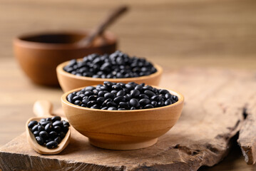 Black bean in bowl with spoon on wooden background, Food ingredient