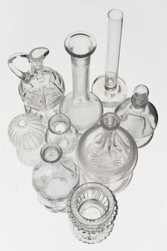 set of glass bottles and vases put on mirror