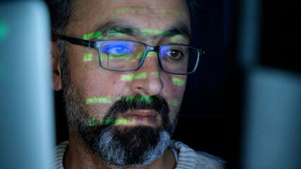 Focused Coder Analyzes Code on Computer Screen in Dark Environment - Cyber security, Cyber Attack, Penetration testing concept.