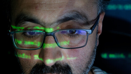 Focused Coder Analyzes Code on Computer Screen in Dark Environment - Cyber security, Cyber Attack,...